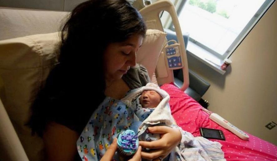 In this photo provided by Andrea Lopez, she cradles her son, Gabriel Crude, at a hospital Bakersfield, Calif., in 2011, where he was born with anencephaly, a rare and severe birth defect tied to a lack of folic acid, a key vitamin. (Courtesy Andrea Lopez via AP)