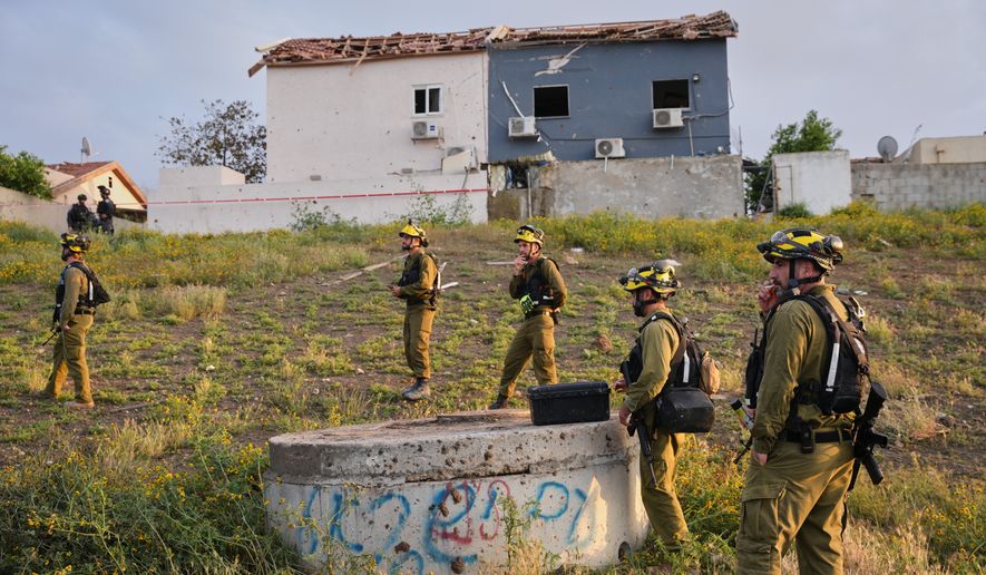 Israeli security forces work at the site of an Iranian missile strike, in Beersheba, southern Israel Sunday, March 29, 2026. (AP Photo/Maya Levin)
