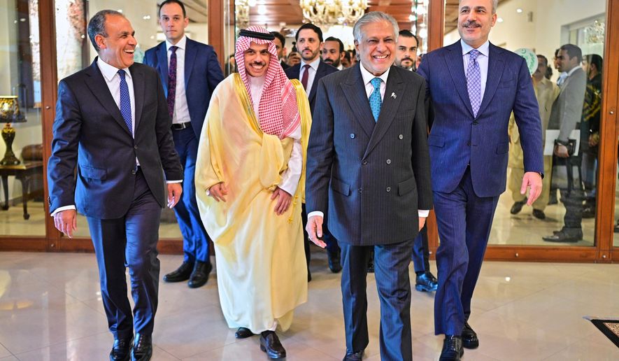 In this photo released by the Pakistan Ministry of Foreign Affairs, from left, Egyptian Foreign Minister Badr Abdelatty, Saudi Arabia's Foreign Minister Prince Faisal bin Farhan Al-Saud, Pakistan's Foreign Minister Ishaq Dar and Turkish Foreign Minister Hakan Fidan walk prior to their meeting to discuss the Middle East war, in Islamabad, Pakistan, Sunday, March 29, 2026. (Pakistan Ministry of Foreign Affairs via AP)