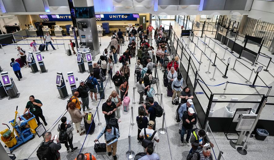 Airline passengers make their way through the security lines, next to a closed screening area, in Terminal C at George Bush Intercontinental Airport, Sunday, March 29, 2026, in Houston. (Brett Coomer/Houston Chronicle via AP)