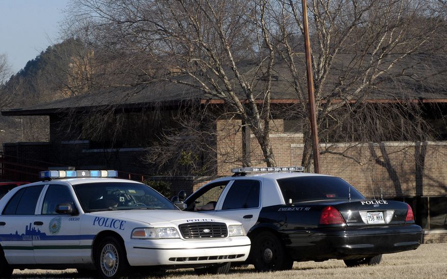 Police cruisers are stationed outside the Arkansas State Medical Board building during a medical board meeting, Feb. 5, 2009, in Little Rock, Ark. (AP Photo/Mike Wintroath)