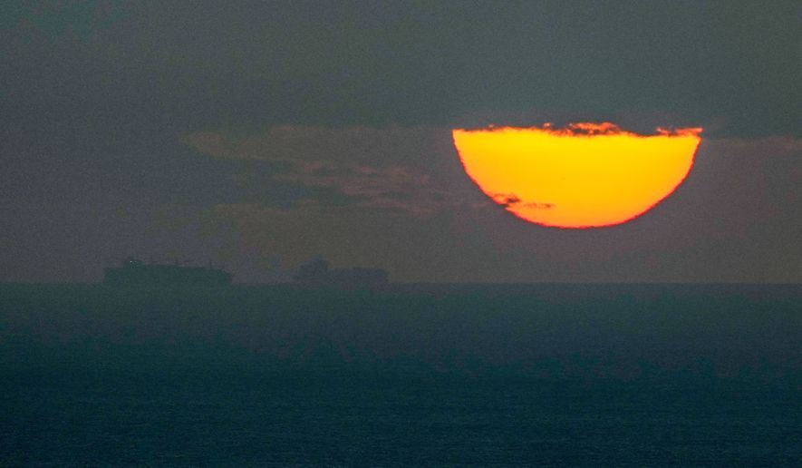 Ships sail through the Arabian Gulf toward the Strait of Hormuz as the sun sets in the United Arab Emirates Monday, March 23, 2026. (AP Photo, File)