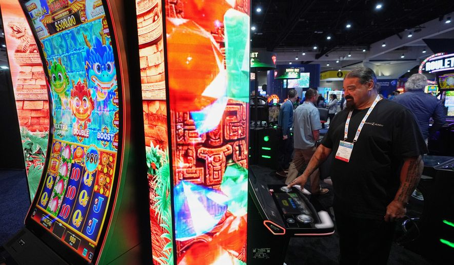William Tucker Jr, a council member of the Sycuan Band of the Kumeyaay Nation from El Cajon, Calif., checks out a display at the Indian Gaming Association's annual convention in San Diego, Thursday, April 2, 2026. (AP Photo/Gregory Bull)