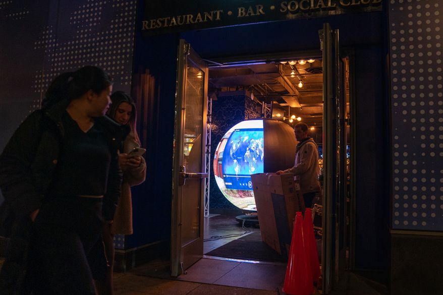 A crew assembles the Polymarket 'Situation Room' pop-up bar at Proper 21 on K Street, Thursday, March 19, 2026, in Washington. (AP Photo/Allison Robbert)