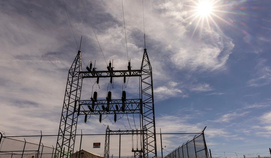 An electrical grid towers over a pump station for the Butte Pipeline Company south of Lusk in eastern Wyoming. (Dan Cepeda/WyoFile via AP)