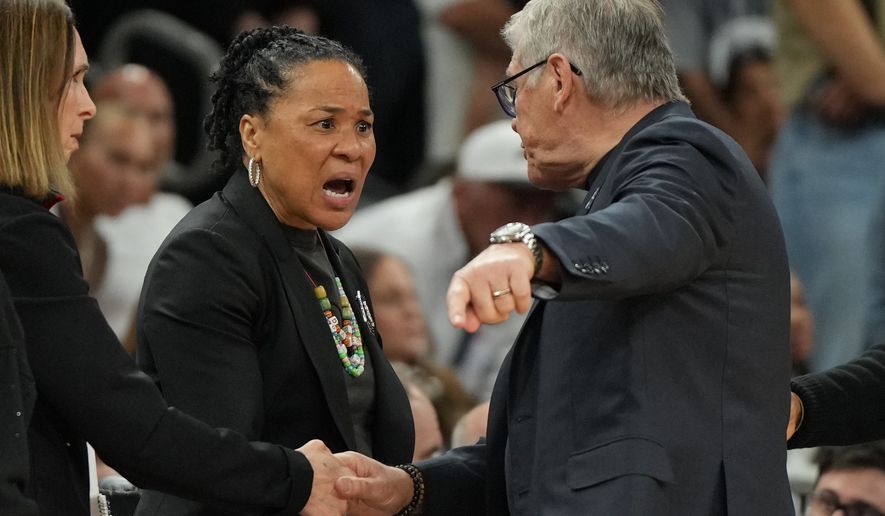 South Carolina head coach Dawn Staley, center, and UConn head coach Geno Auriemma argue after a woman's NCAA college basketball tournament semifinal game at the Final Four, Friday, April 3, 2026, in Phoenix. (AP Photo/Rick Scuteri)