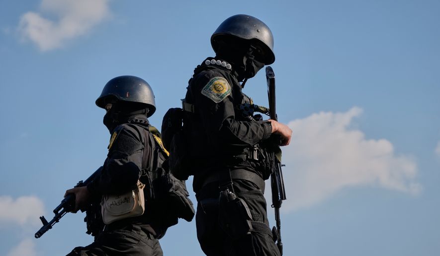 Iranian police special forces stand guard during a funeral procession for Alireza Tangsiri, head of Iran's Islamic Revolutionary Guard Corps Navy, and others killed in Israeli strikes in late March, in Tehran, Iran, Wednesday, April 1, 2026. (AP Photo/Vahid Salemi) ** FILE **