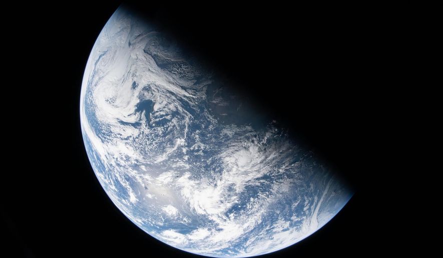 This image from video provided by NASA shows a view of earth taken by NASA astronaut and Artemis II Commander Reid Wiseman from one of the Orion spacecraft's four windows after completing the translunar injection burn, Thursday, April 2, 2026. (NASA via AP)