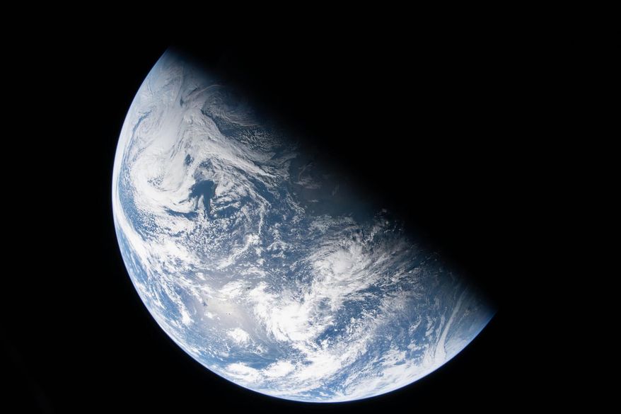 This image from video provided by NASA shows a view of earth taken by NASA astronaut and Artemis II Commander Reid Wiseman from one of the Orion spacecraft's four windows after completing the translunar injection burn, Thursday, April 2, 2026. (NASA via AP)