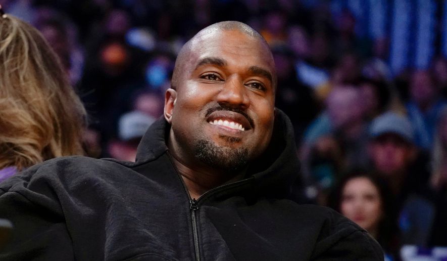 Kanye West, known as Ye, watches the first half of an NBA basketball game between the Washington Wizards and the Los Angeles Lakers, on March 11, 2022, in Los Angeles. (AP Photo/Ashley Landis, File)