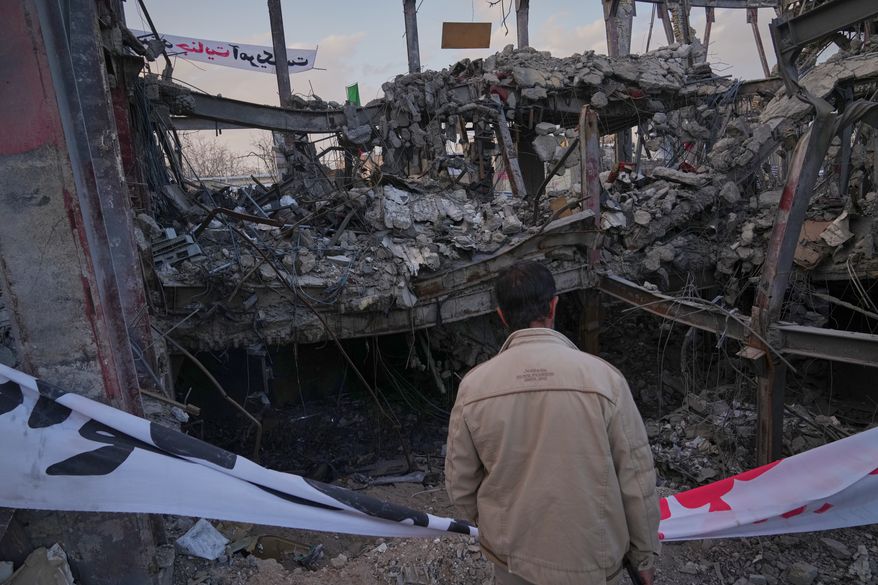 A man looks at a destroyed building within the Grand Hosseiniyeh complex that officials say was hit by U.S.-Israeli airstrikes Tuesday in Zanjan, Iran, Saturday, April 4, 2026. (AP Photo/Francisco Seco)