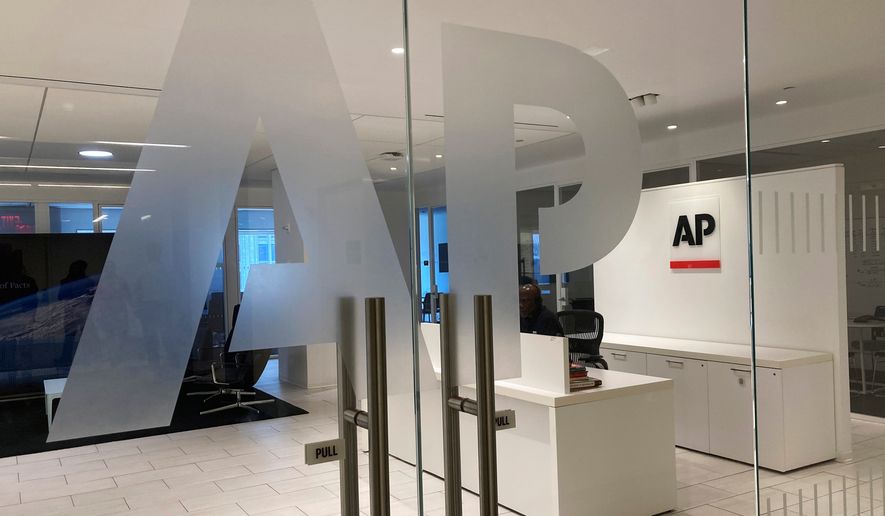 The Associated Press logo is shown at the entrance to the news organization's office in New York on July 13, 2023. (AP Photo/Aaron Jackson) **FILE**