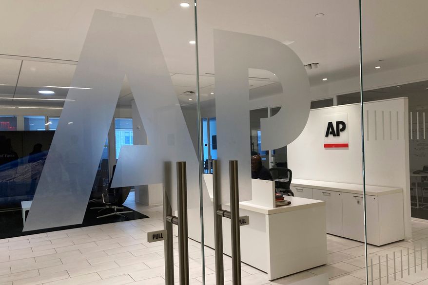 The Associated Press logo is shown at the entrance to the news organization's office in New York on July 13, 2023. (AP Photo/Aaron Jackson) **FILE**