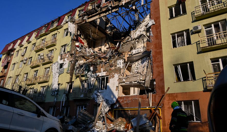 A rescue worker walks in front of residential building which was heavily damaged after a Russian strike in Odesa, Ukraine, Monday, April 6, 2026. (AP Photo/Michael Shtekel)