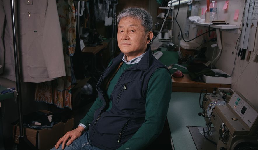 Tailor, Kil Bae, poses for a photo inside his shop on Friday, March 27, 2026, in New York. (AP Photo/Andres Kudacki)