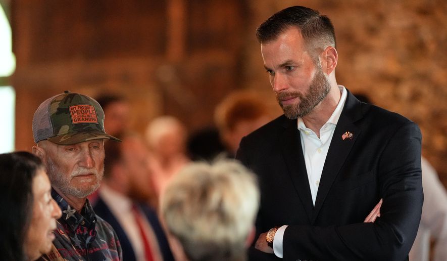 Republican candidate Clay Fuller, right, speaks to supporters during an election night watch party, Tuesday, April 7, 2026, in Ringgold, Ga. (AP Photo/Mike Stewart)