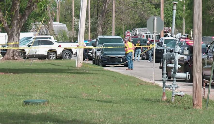 In this image taken from video provided by Oklahoma television station KFOR, authorities block off an area following a shooting inside a high school, Tuesday, April 7, 2026, in Pauls Valley, Okla. (KFOR via AP)