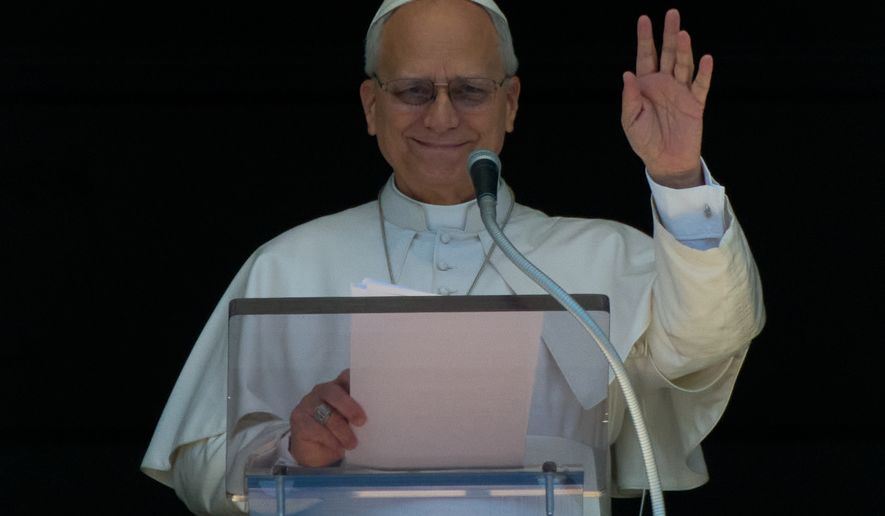 Pope Leo XIV delivers his blessing as he recites the Regina Coeli noon prayer from the window of his studio overlooking St.Peter's Square, at the Vatican, Monday, April 6, 2026. (AP Photo/Andrew Medichini)