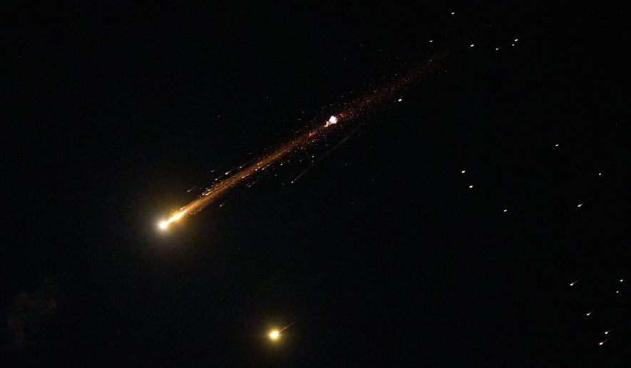 An Iranian cluster munition missile explodes in the sky over northern Israel, Wednesday, April 8, 2026. (AP Photo/Ariel Schalit) ** FILE **