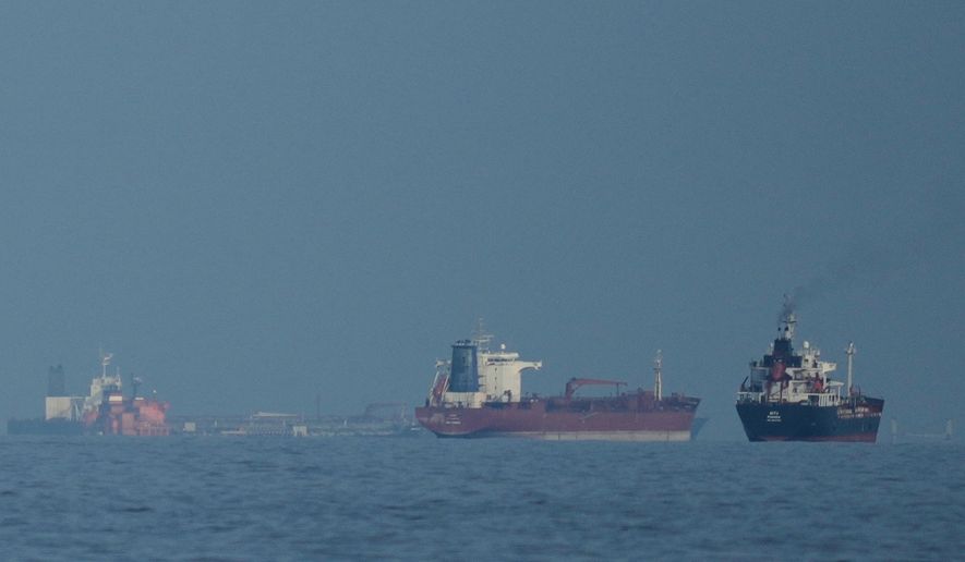 Oil tankers and cargo ships line up in the Strait of Hormuz as seen from Khor Fakkan, United Arab Emirates, Wednesday, March 11, 2026. (AP Photo/Altaf Qadri, File)