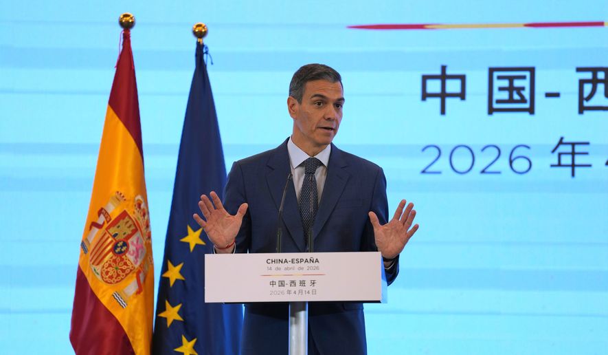 Spain's Prime Minister Pedro Sanchez gestures as he speaks during a press conference in Beijing, China, Tuesday, April 14, 2026. (AP Photo/Ng Han Guan)