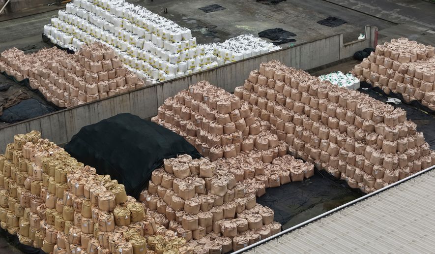 Bags of imported solid sulfur are seen at a port in Nanjing in eastern China's Jiangsu province, Tuesday, April 14, 2026. (Chinatopix Via AP) CHINA OUT