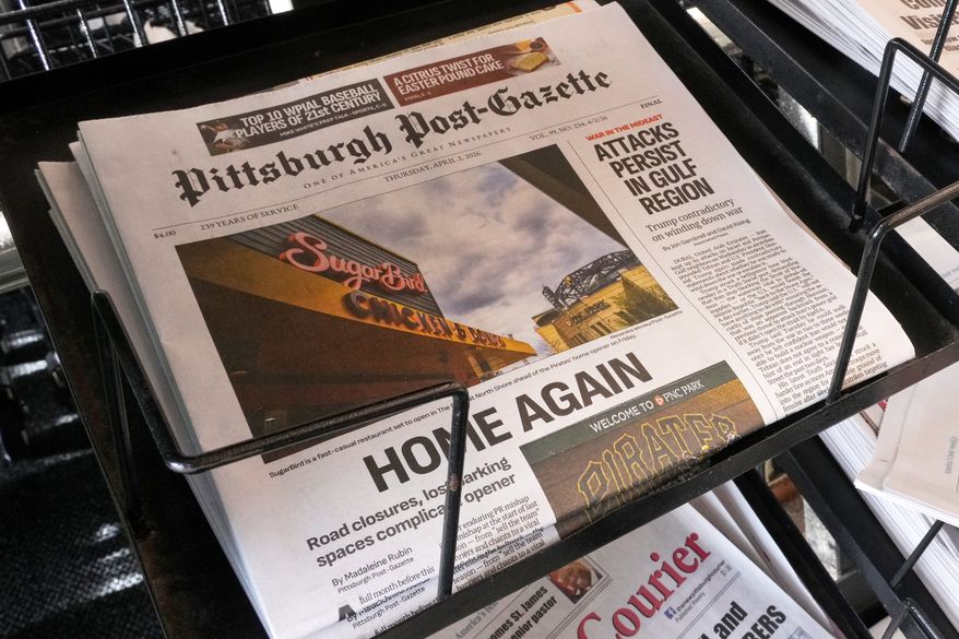 The printed edition of the Pittsburgh Post-Gazette sits in a newspaper rack, Thursday, April 2, 2026, in Pittsburgh. (AP Photo/Gene J. Puskar)