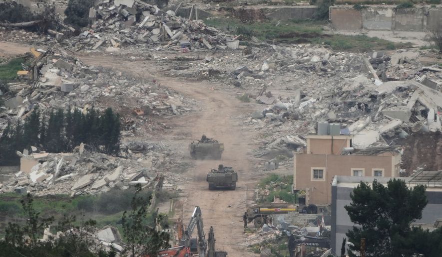 Israeli army vehicles and bulldozers operate in southern Lebanon, as seen from northern Israel, Wednesday, April 15, 2026. (AP Photo/Ariel Schalit)