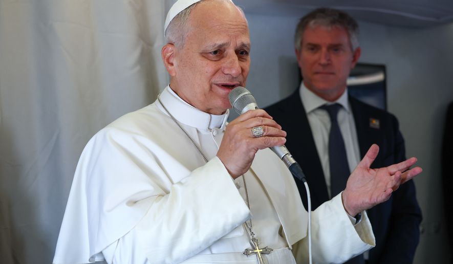 Pope Leo XIV speaks to journalists aboard his flight bound for Yaounde-Nsimalen International Airport, Cameroon, Wednesday, April 15, 2026, on the third day of an 11-day apostolic journey to Africa. (Guglielmo Mangiapane/Pool Photo via AP)