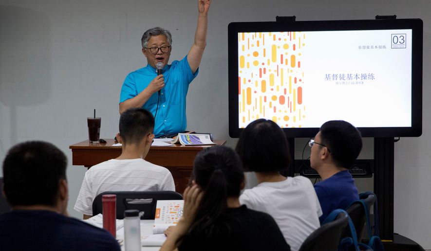 Pastor Ezra Jin Mingri leads a class on the basics of Christian beliefs at Zion Church in Beijing, Aug. 4, 2018. (AP Photo/Ng Han Guan, File)