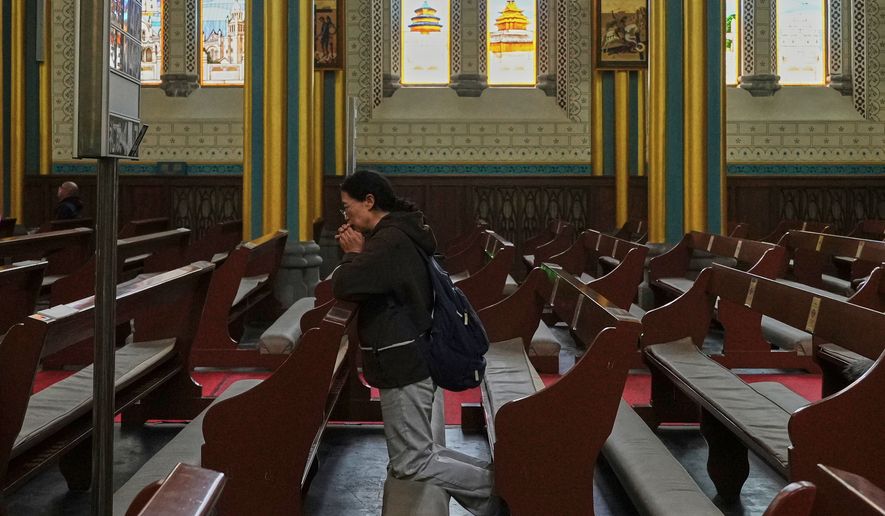 A person prays at the Xishiku Catholic Church, in Beijing, May 9, 2025. (AP Photo/Andy Wong, File)