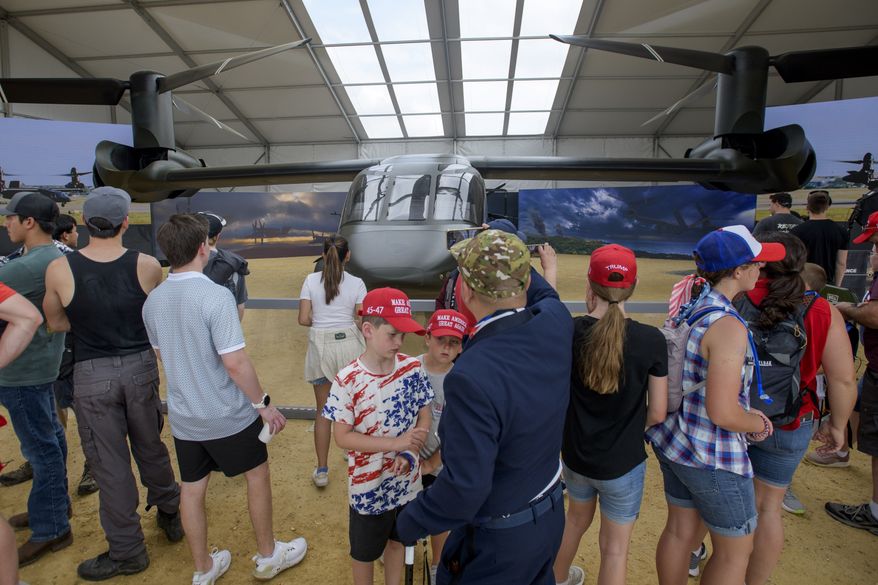 People stop to look at and pose for photos with the Bell MV-75 Future Long Range Assault Aircraft during an event to honor the Army's 250th anniversary, coinciding with President Donald Trump's 79th birthday, Saturday, June 14, 2025, in Washington. (AP Photo/Rod Lamkey Jr.) **FILE**