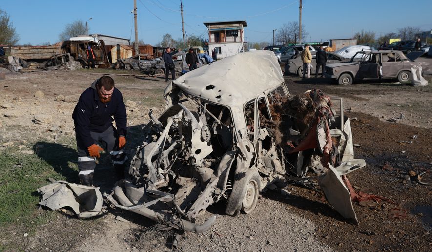 Cars damaged by Russia's drone attack are seen in Zaporizhzhia, Ukraine, Wednesday, April 15, 2026. (AP Photo/Kateryna Klochko)