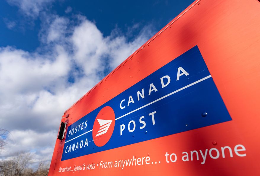 A Canada Post mail truck is seen parked in their distribution center, in Montreal, Nov. 27, 2024. (Christinne Muschi/The Canadian Press via AP, File)