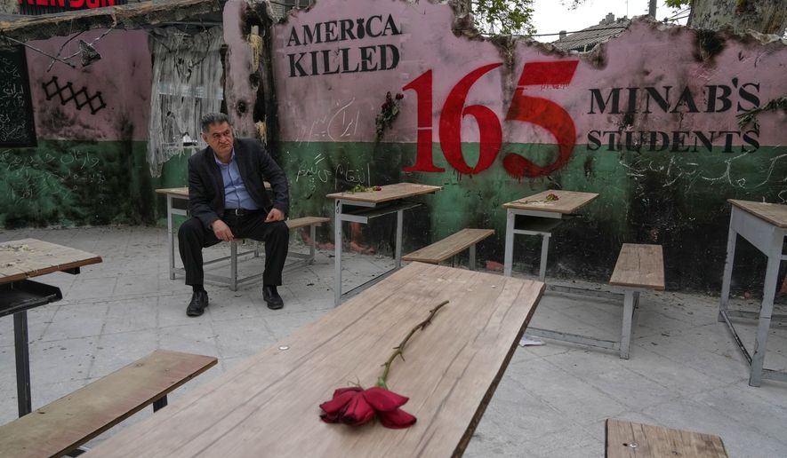 FILE - A man sits on a bench in a memorial, set for the school children who were killed during a strike on a school in southern town of Minab on Feb. 28, in northern Tehran, Iran, Sunday, April 12, 2026. (AP Photo/Vahid Salemi, File)