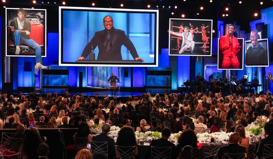 Eddie Murphy accepts the 51st AFI Life Achievement Award during a tribute to him on Saturday, April 18, 2026, at the Dolby Theatre in Los Angeles. (AP Photo/Chris Pizzello)