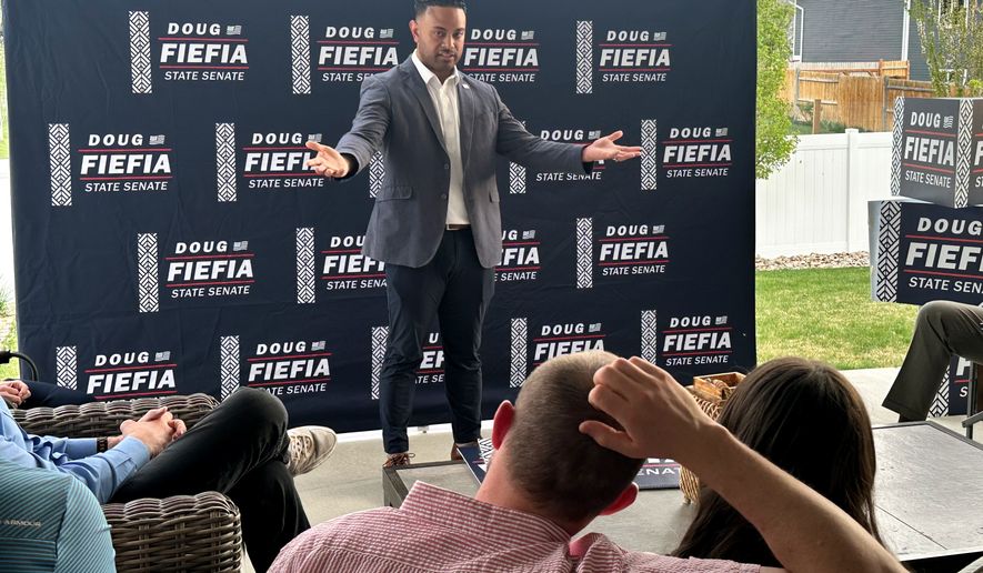 Utah State Rep. Doug Fiefia talks to Utah voters on the back deck of a house, Thursday, April 9, 2026, in Riverton, Utah. Fiefia, a Republican, has a background in technology and is running for the state senate with a pledge to tackle AI. (AP Photo/Nicholas Riccardi)