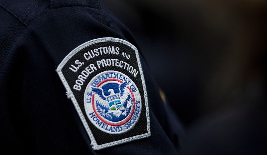 A customs agent wears a patch for the U.S. Customs and Border Protection agency, Oct. 27, 2017, at John F. Kennedy International Airport in New York. (AP Photo/Mark Lennihan, file)
