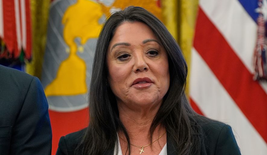 Then-Labor Secretary Lori Chavez-DeRemer listens as President Donald Trump speaks with reporters while signing executive orders in the Oval Office of the White House, April 23, 2025, in Washington. (AP Photo/Alex Brandon, File)