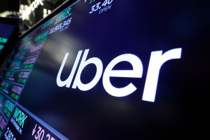 The Uber logo appears above a trading post on the floor of the New York Stock Exchange, Aug. 16, 2019. (AP Photo/Richard Drew) **FILE**