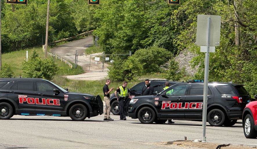 Police block a road near a chemical plant where a leak occurred Wednesday, April 22, 2026, in Institute, W.Va. (AP Photo/John Raby)