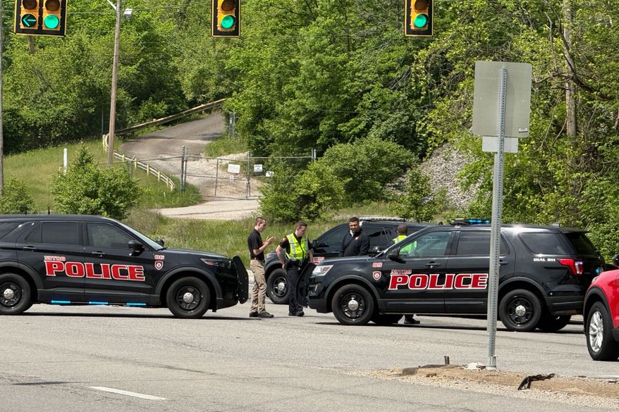 Police block a road near a chemical plant where a leak occurred Wednesday, April 22, 2026, in Institute, W.Va. (AP Photo/John Raby)