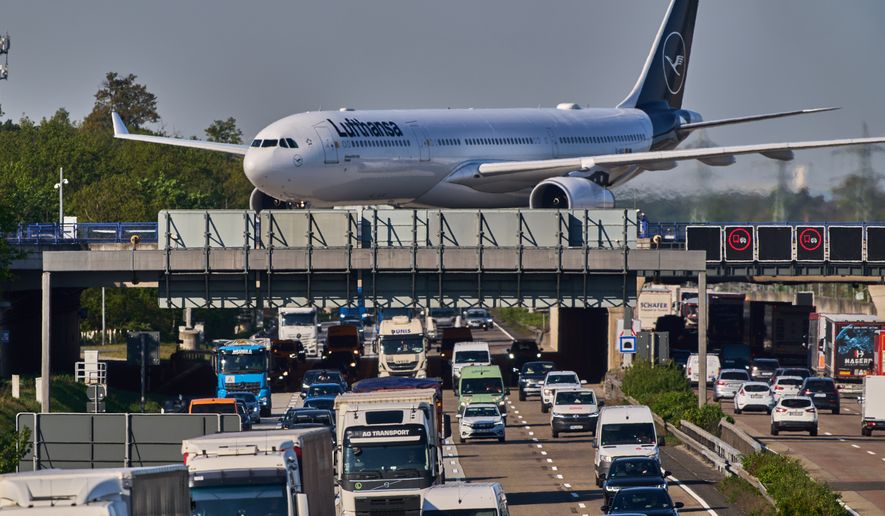 A Lufthansa aircraft rolls on a bridge over a highway at the airport in Frankfurt, Germany, Wednesday, April 22, 2026. (AP Photo/Michael Probst)