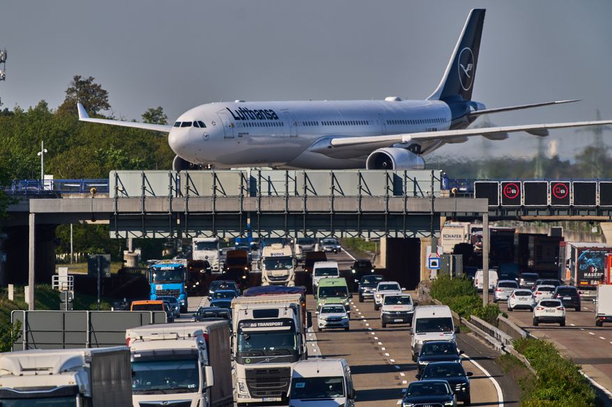 A Lufthansa aircraft rolls on a bridge over a highway at the airport in Frankfurt, Germany, Wednesday, April 22, 2026. (AP Photo/Michael Probst)