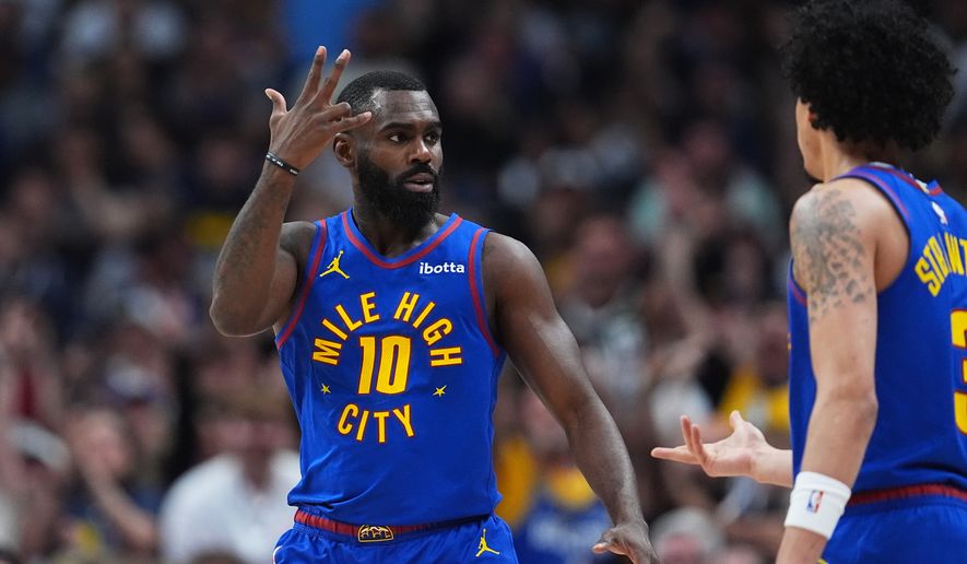 Denver Nuggets guard Tim Hardaway Jr., left, gestures after hitting a 3-point basket as guard Julian Strawther looks on in the second half of an NBA basketball game against the Golden State Warriors Sunday, March 29, 2026, in Denver. (AP Photo/David Zalubowski)