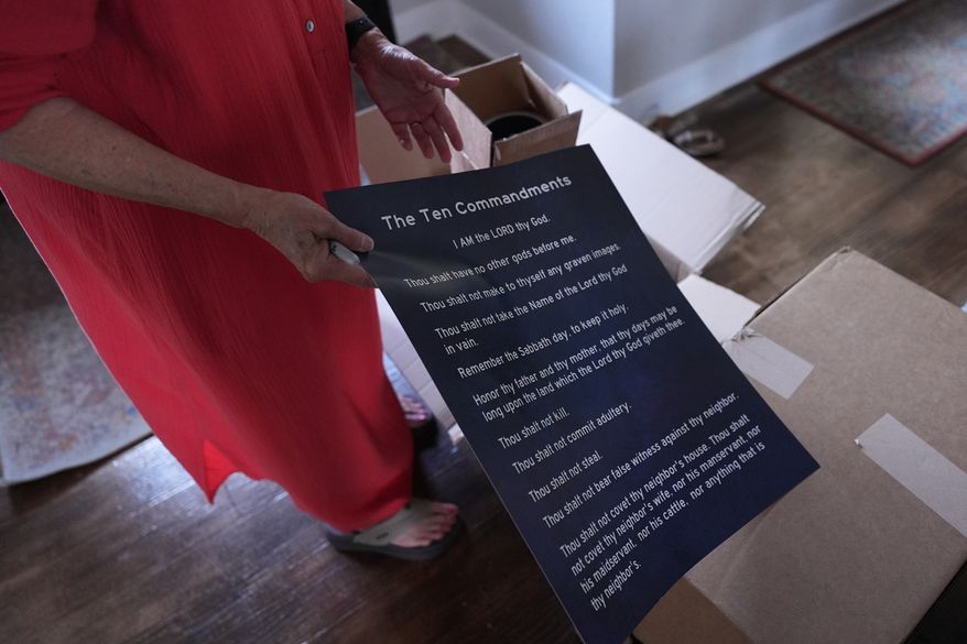 A woman prepares to deliver hundreds of Ten Commandments posters to local public schools in New Braunfels, Texas, on Nov. 17, 2025. (AP Photo/Eric Gay) **FILE**