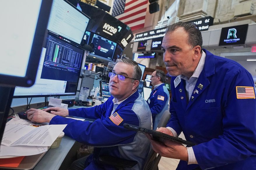 Traders Jim Bodner, left, and Chris Lagana work on the floor of the New York Stock Exchange, Thursday, April 23, 2026. (AP Photo/Richard Drew)