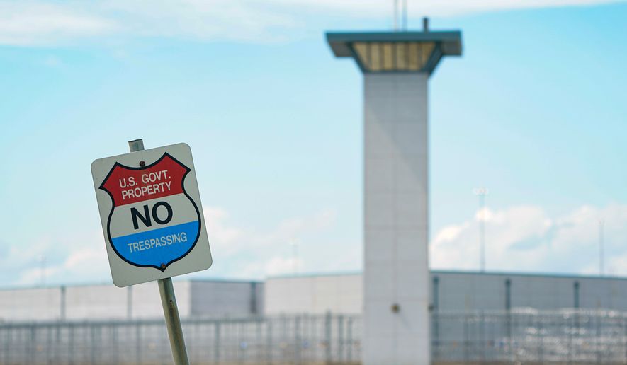 A "No trespassing" sign is displayed outside the federal prison complex in Terre Haute, Ind., on Friday, Aug. 28, 2020. (AP Photo/Michael Conroy) **FILE**