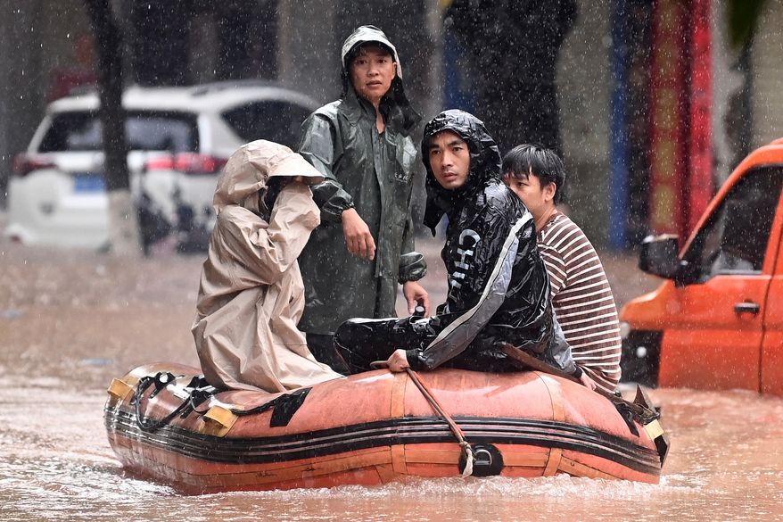 In this photo released by Xinhua News Agency, stranded residents are evacuated on a boat after flooding from heavy rainfall in Qinzhou in southern China's Guangxi Zhuang Autonomous Region on Monday, April 27, 2026. (Zhang Ailin/Xinhua via AP)