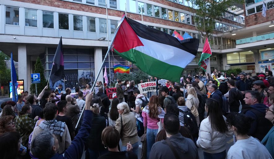 People attend a rally against Israel's participation in the Eurovision Song Contest in front of the state-run TV headquarters in Belgrade, Serbia, Tuesday, April 28, 2026. (AP Photo/Darko Vojinovic)